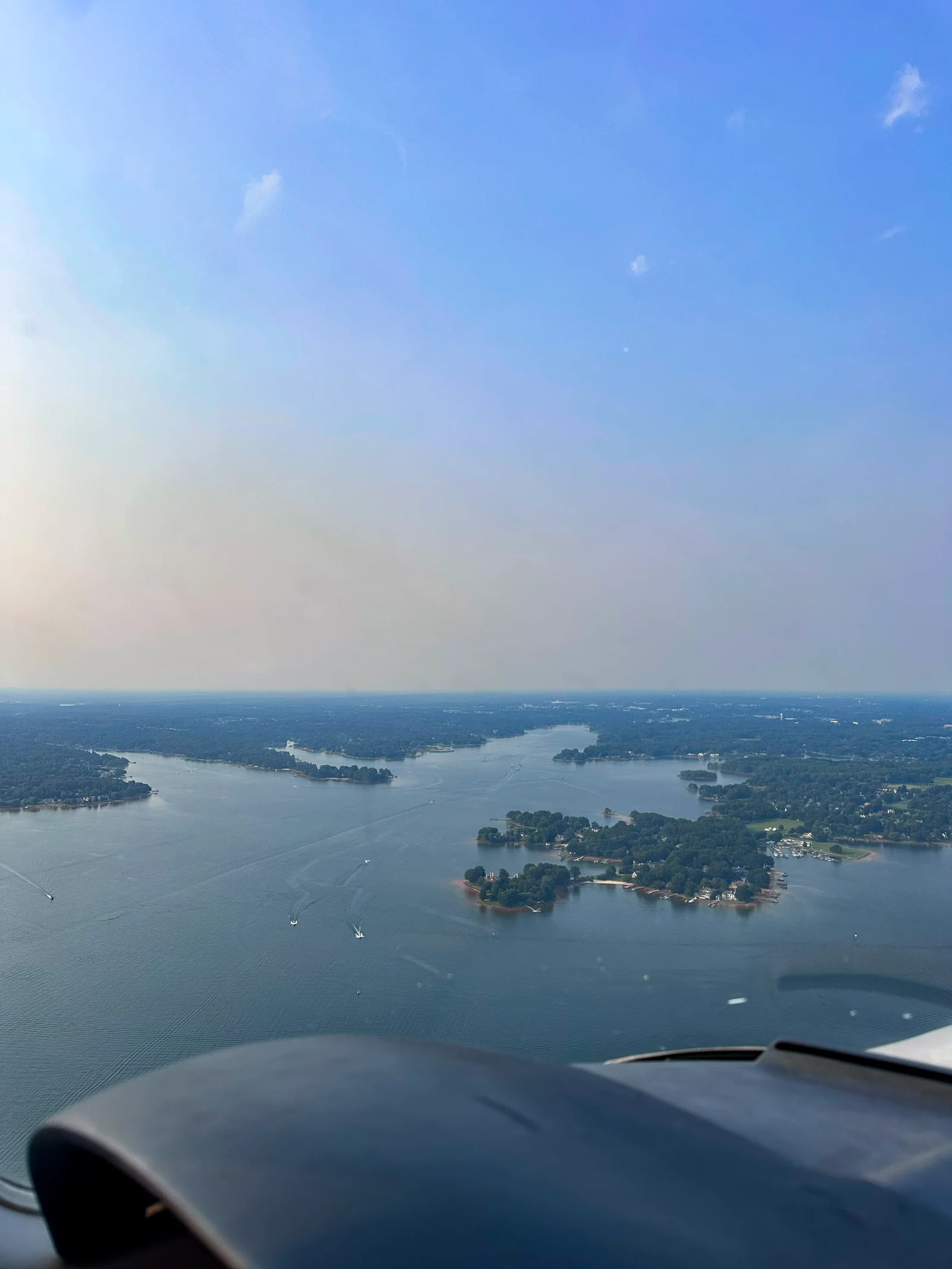 View from a light aircraft over a lake in warm evening light